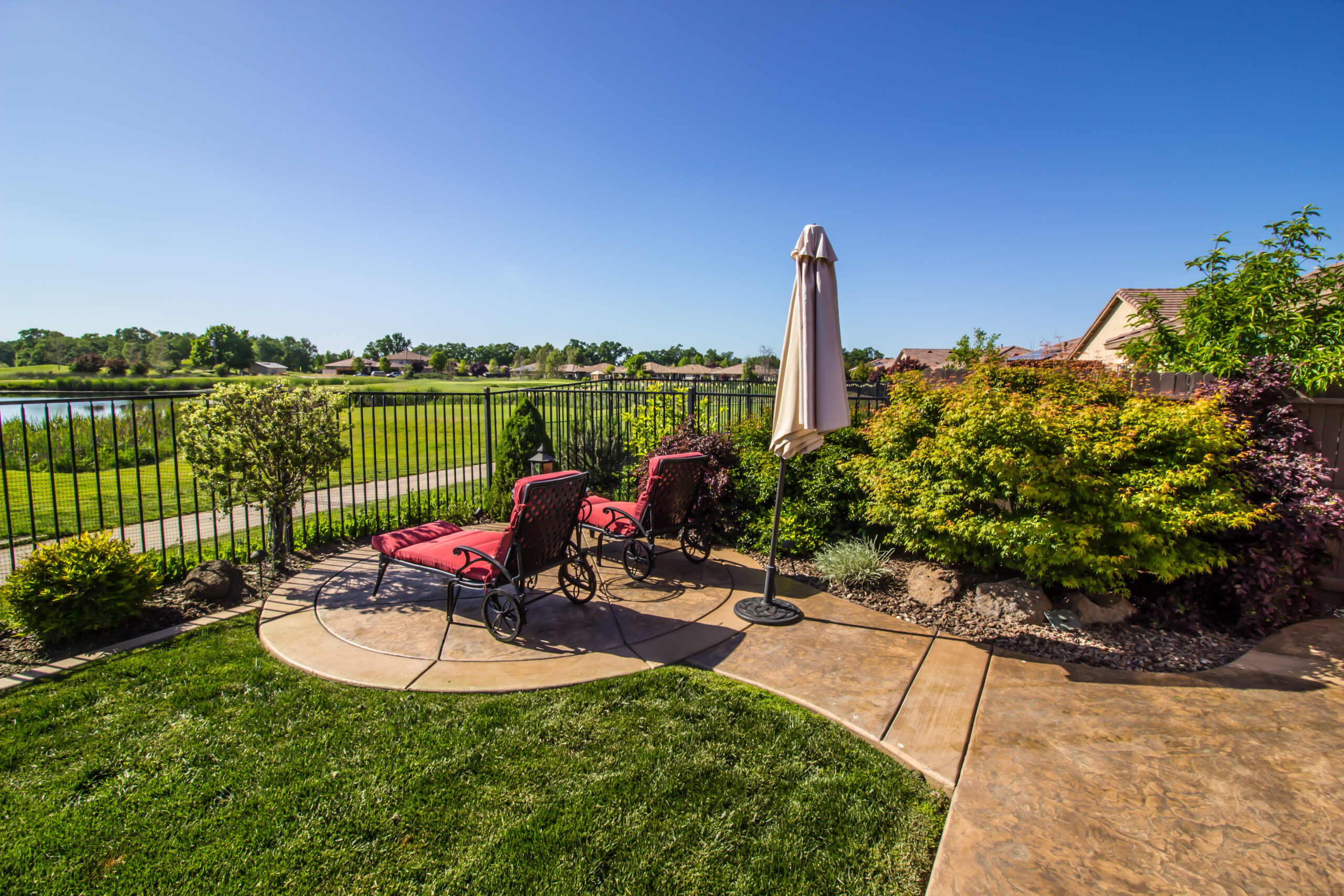 Lounge Chairs Overlooking Green Field & Blue Pond